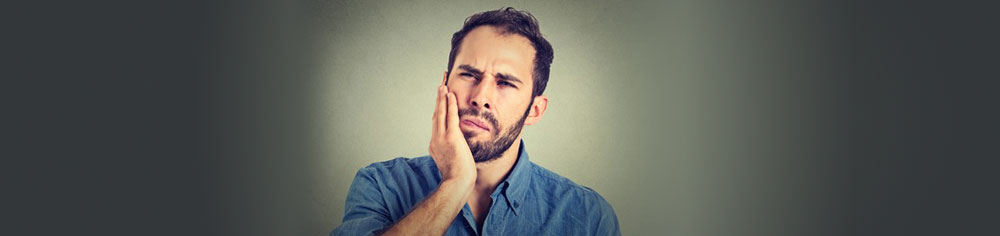 Problems caused by Wisdom Teeth - a young man in pain